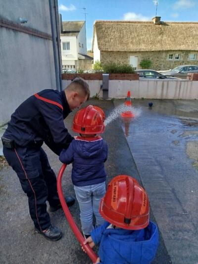 Photo pompiers avec enfants et lance incendie
